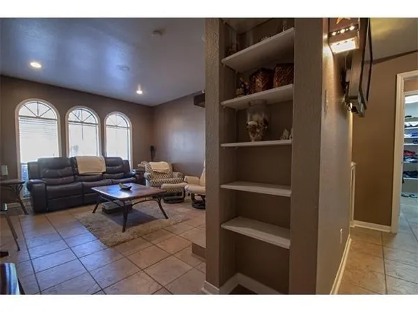 a living room with furniture a rug and a window