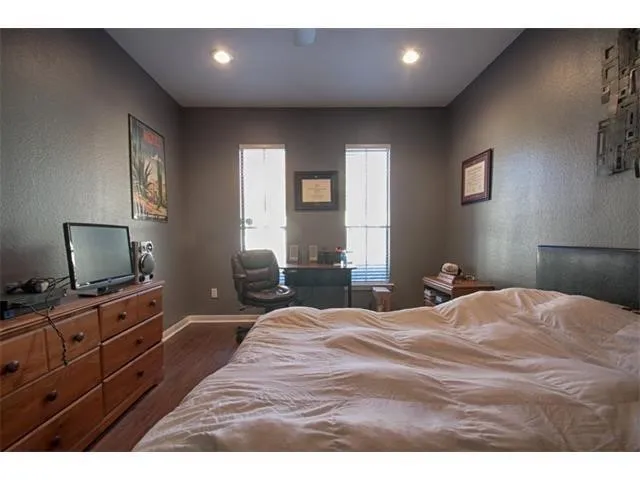 a bedroom with a bed and a dresser