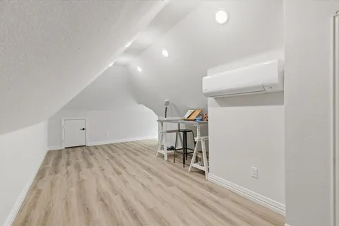 a view of a room with furniture and wooden floor