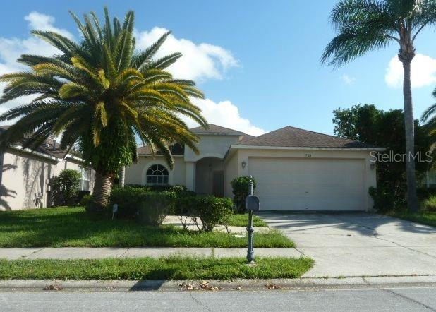 1750 Citron Court Trinity, FL 34655 - Photo 1 of 1 a front view of house with a garden