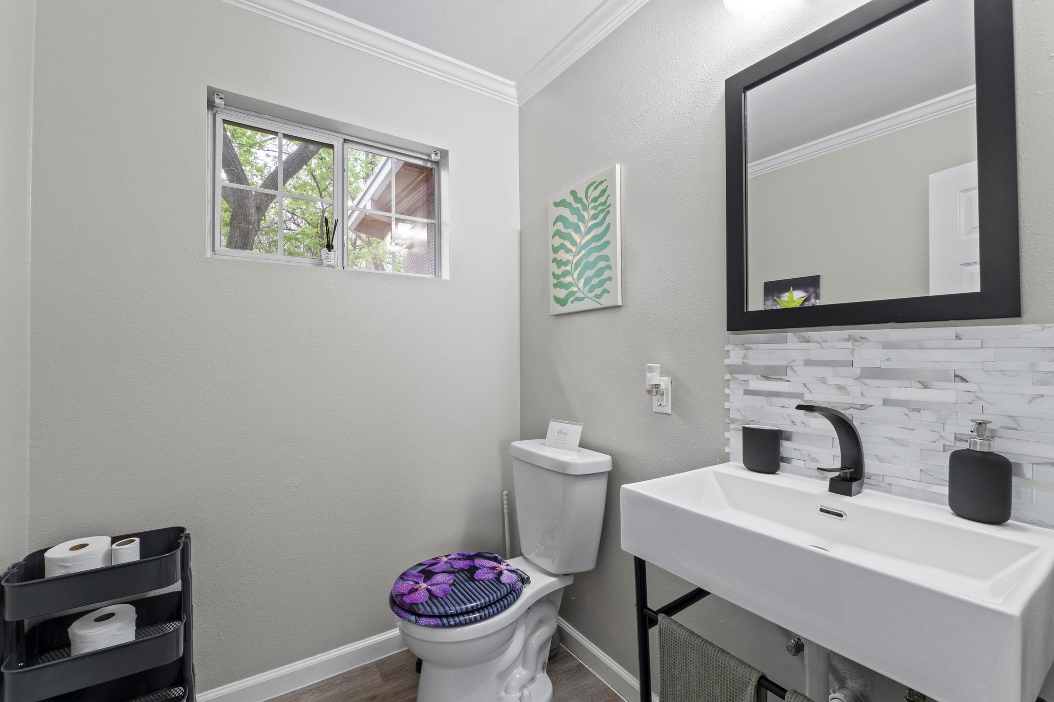 4512 Speedway, Unit A Austin, TX 78751 - Photo 32 of 39 a bathroom with a toilet a sink and mirror