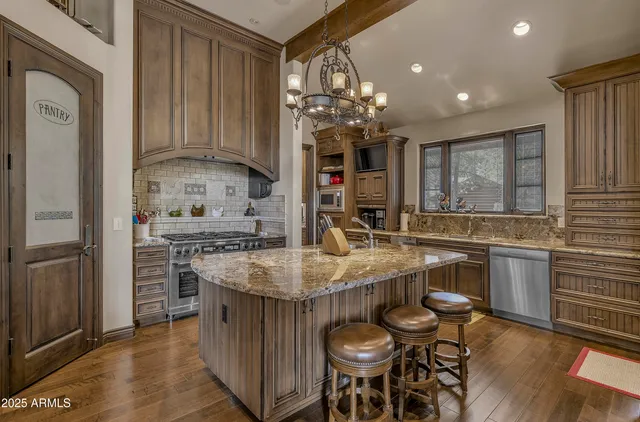 a kitchen with stainless steel appliances granite countertop a stove and a refrigerator