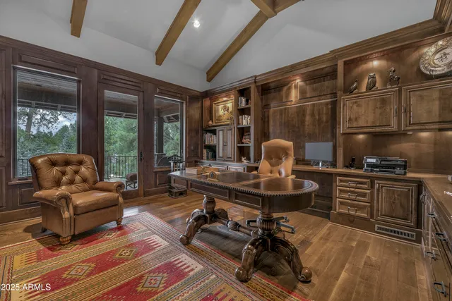 a view of a hallway with wooden floor and a living room