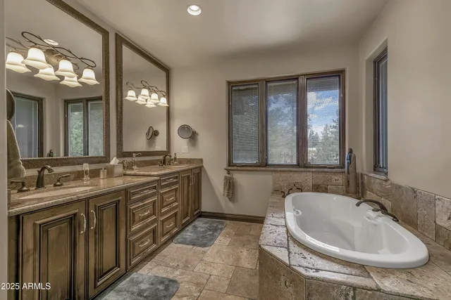 a bedroom with bed and a chandelier