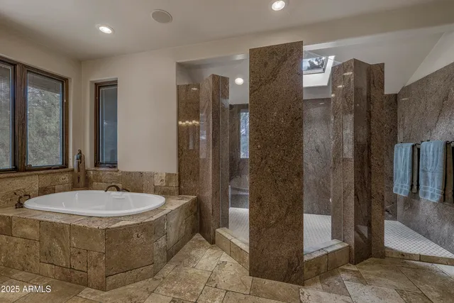 a bedroom with bed and a chandelier