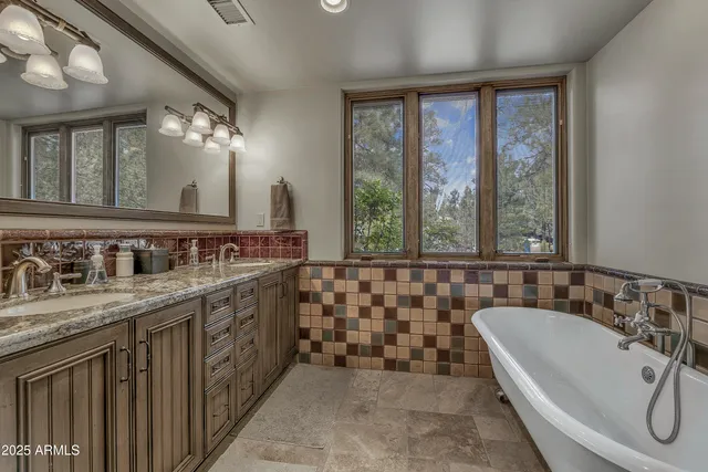 a bedroom with a bed a dresser and mirror