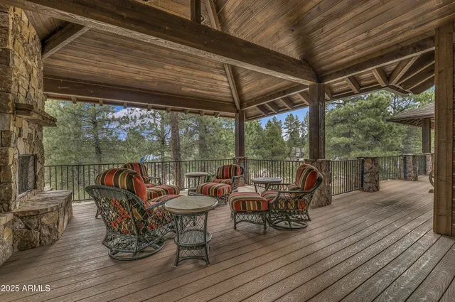 a view of a chairs and table in the deck under an umbrella