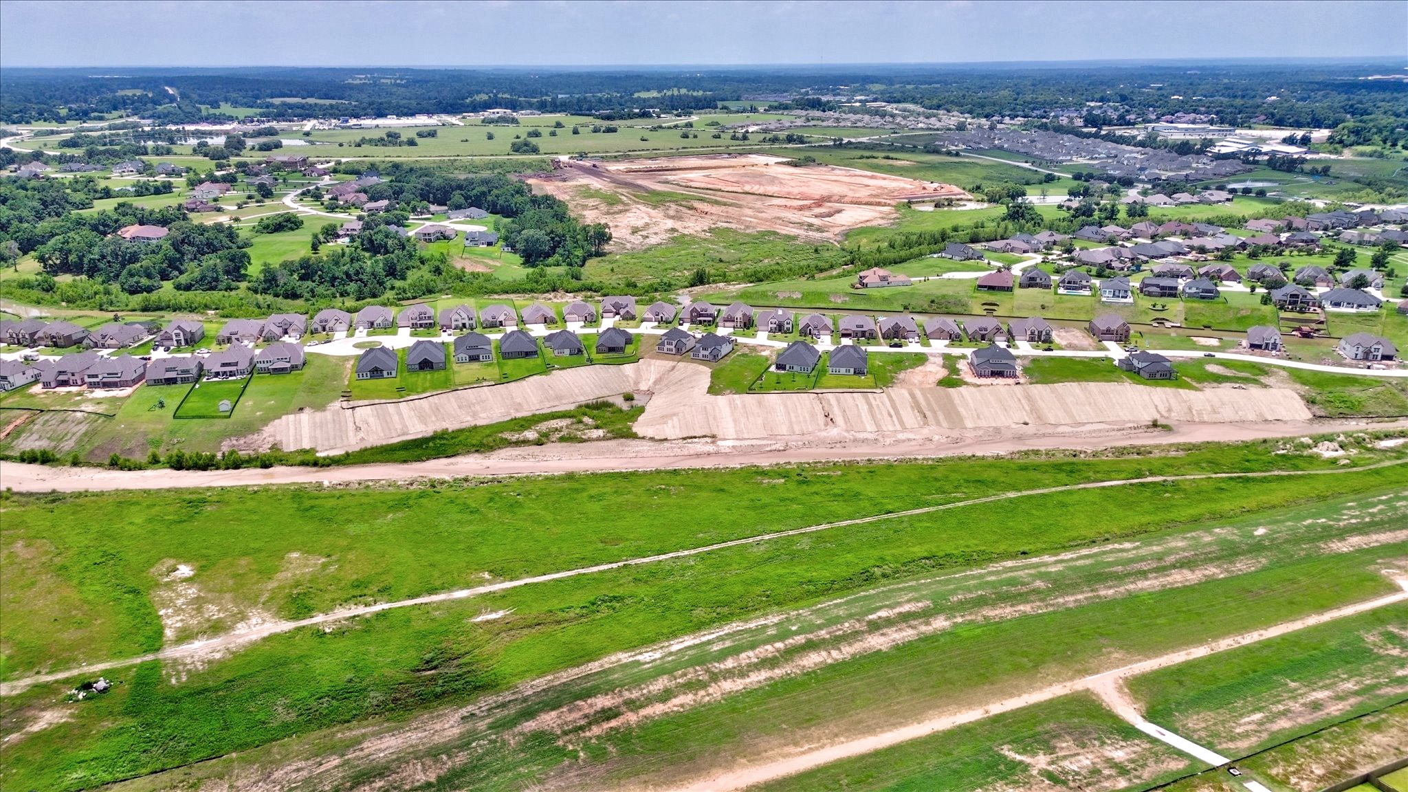 141 Peninsula Point Drive Montgomery, TX 77356 - Photo 46 of 47 A sweeping aerial view showcasing the full row of Waterstone homes along the greenbelt. The gently sloping lots and unobstructed rear views offer an ideal mix of beauty and privacy.