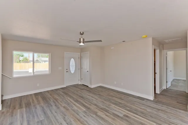 wooden floor in an empty room with a window