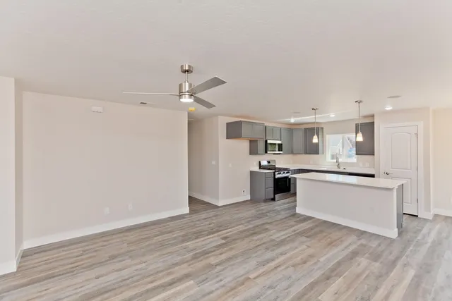 a large kitchen with a wooden floor and a view of kitchen