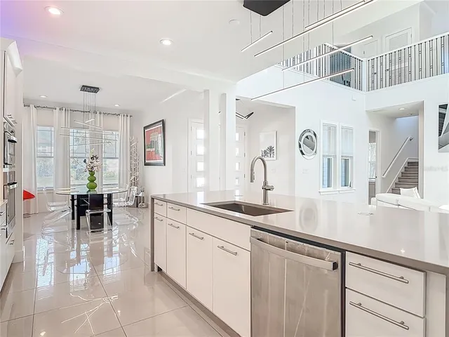 an open kitchen with sink and cabinets