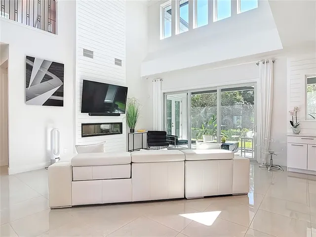 a living room filled with furniture and a potted plant