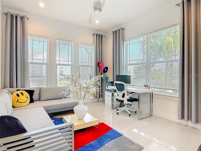 a living room with furniture fireplace and a large window