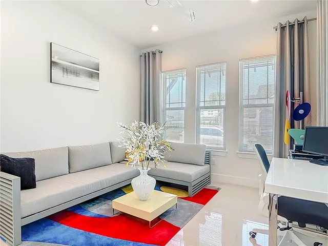 a living room with furniture and a potted plant