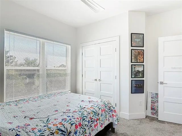 a bedroom with a bed and a painting on the wall