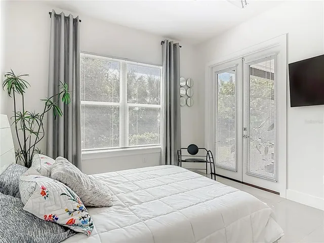 a bedroom with a bed and a flat screen tv