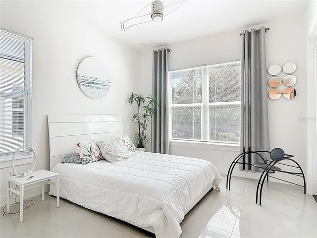 a bedroom with a bed and a potted plant