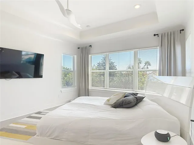 a bedroom with a bed and a painting on the wall