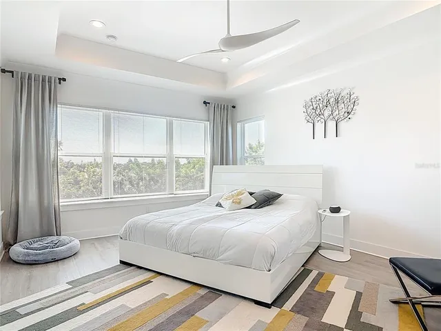 a bedroom with a bed and a television