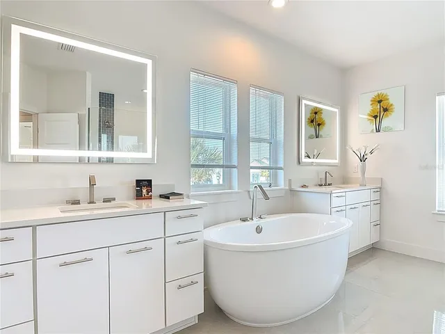 a white bath tub sitting next to a white sink