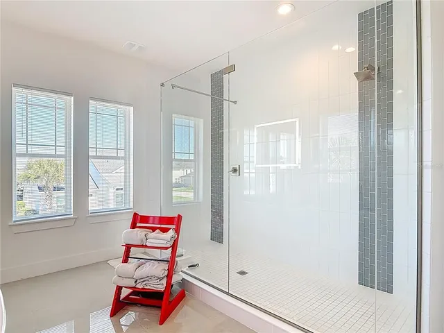a bathroom with a sink mirror vanity and window
