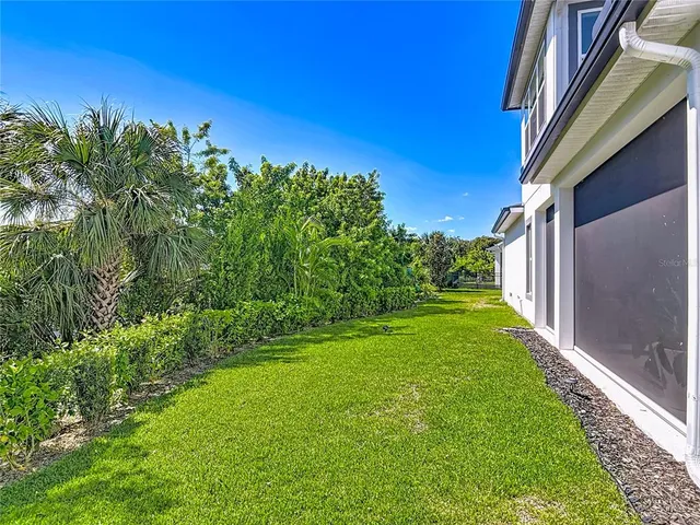 an aerial view of a house with a yard and garden