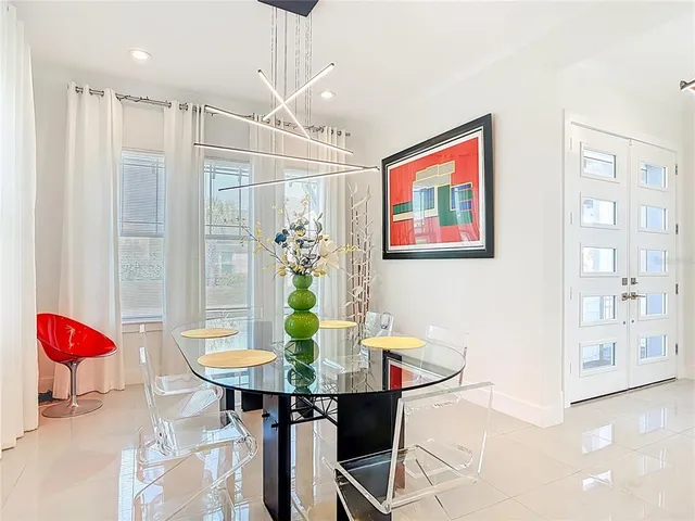 a view of a dining room with furniture and chandelier