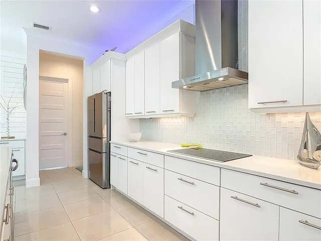 a kitchen with stainless steel appliances granite countertop a refrigerator sink and cabinets