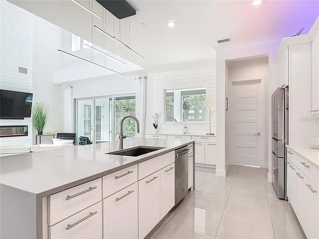 a kitchen with a refrigerator and a sink