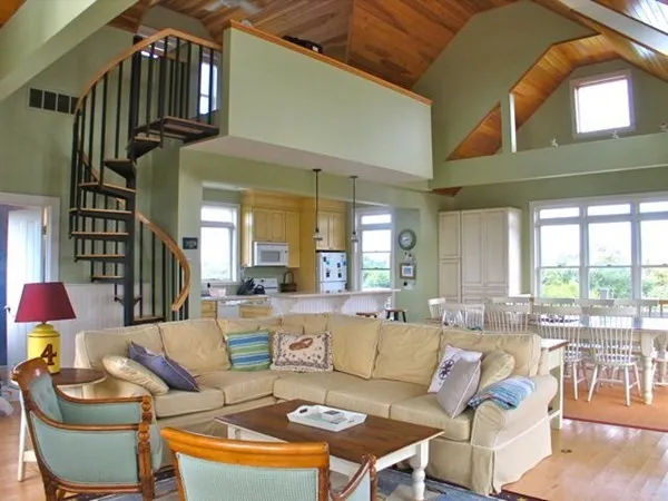 a living room with furniture a fireplace and a large window