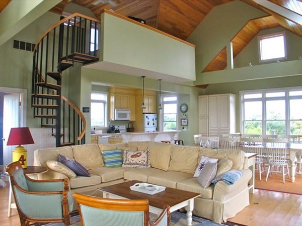 76 Mattakesett Way Edgartown, MA 02539 - Photo 2 of 28 a living room with furniture a fireplace and a large window