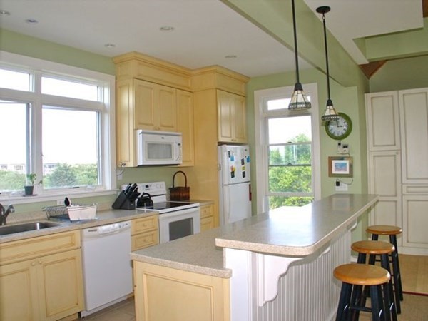 76 Mattakesett Way Edgartown, MA 02539 - Photo 25 of 28 a kitchen that has a sink a stove and a window with chairs
