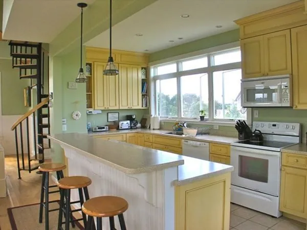 a kitchen with stainless steel appliances granite countertop a sink a stove and a refrigerator