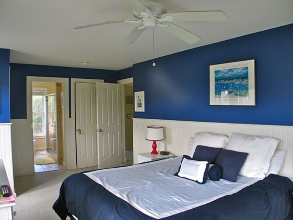 76 Mattakesett Way Edgartown, MA 02539 - Photo 8 of 28 a bedroom with a bed and a dresser