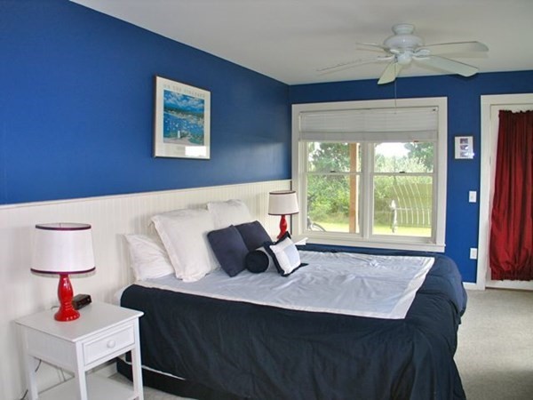 76 Mattakesett Way Edgartown, MA 02539 - Photo 9 of 28 a bedroom with a bed and a window