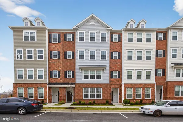 a front view of a residential apartment building with a yard