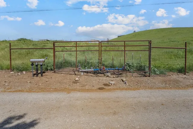 a spacious bedroom with a bed and a chandelier
