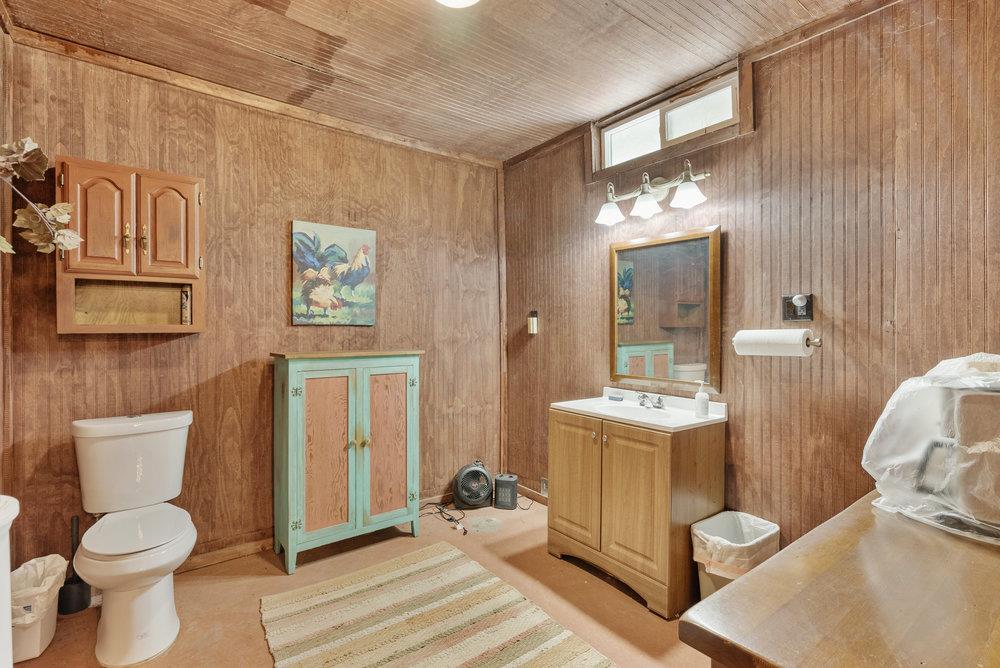 804 Comstock Road Hollister, CA 95023 - Photo 23 of 47 a bathroom with a toilet sink and mirror