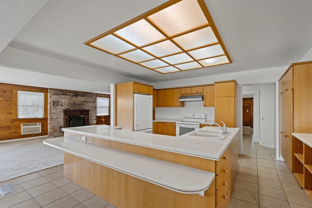 804 Comstock Road Hollister, CA 95023 - Photo 25 of 47 a large kitchen with stainless steel appliances wooden floor and a large window