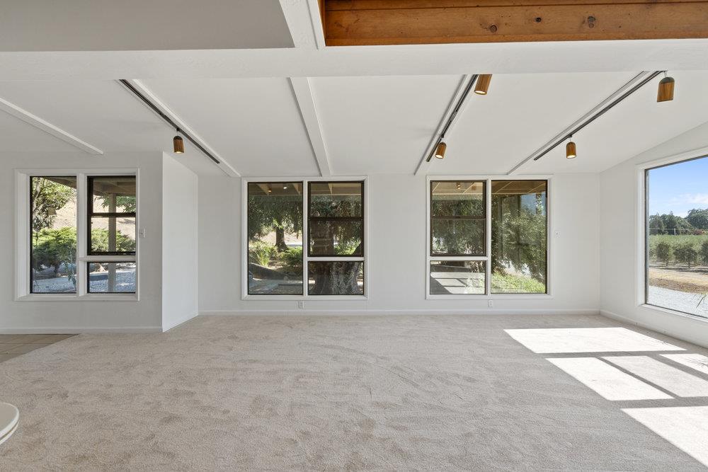 804 Comstock Road Hollister, CA 95023 - Photo 27 of 47 a view of an empty room with windows and chandelier