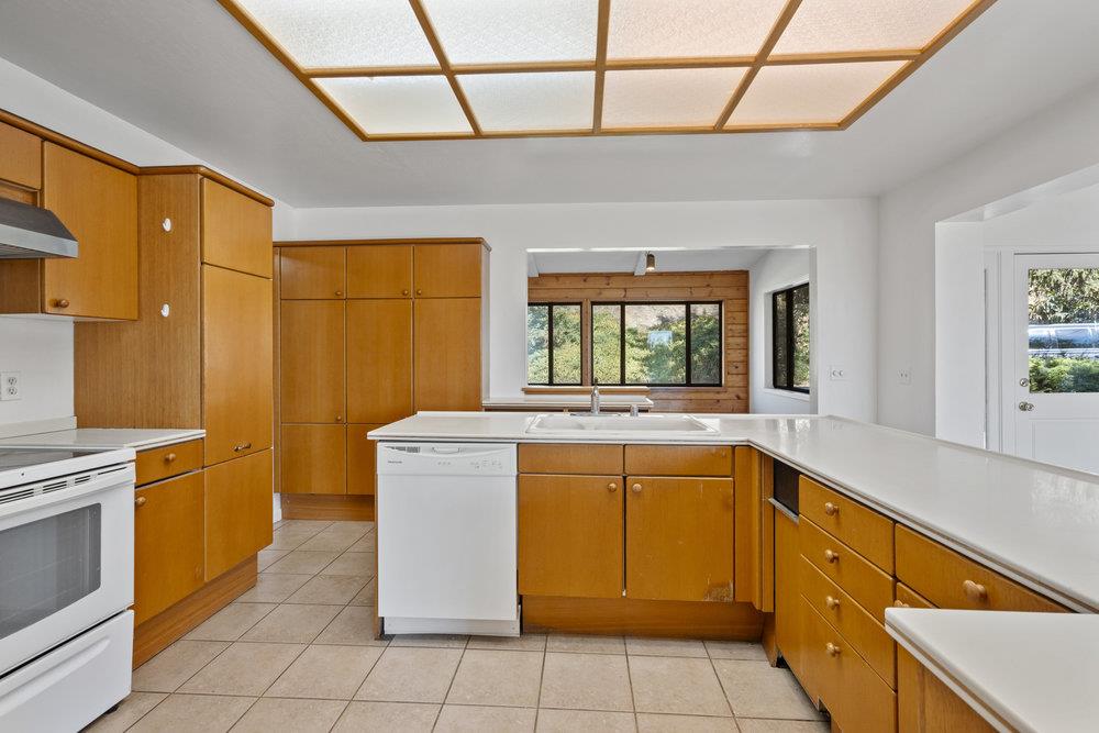 804 Comstock Road Hollister, CA 95023 - Photo 29 of 47 a kitchen with a stove top oven cabinets and a refrigerator