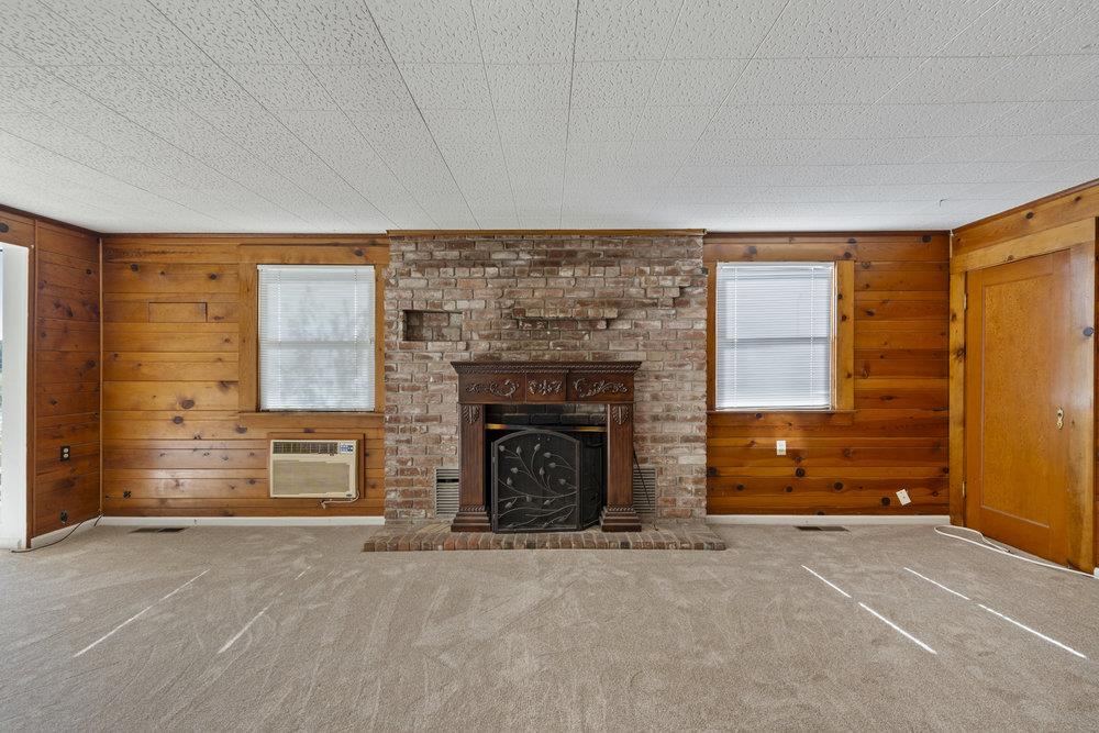804 Comstock Road Hollister, CA 95023 - Photo 31 of 47 an empty room with a fireplace and window