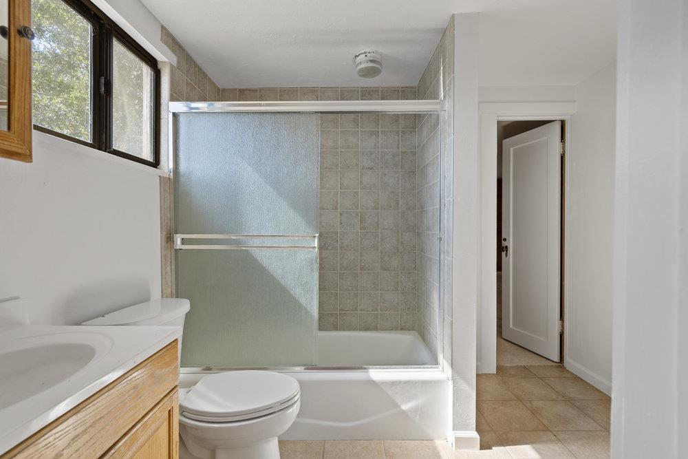 804 Comstock Road Hollister, CA 95023 - Photo 36 of 47 a bathroom with a shower a toilet and sink