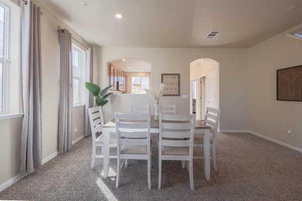 a dining room with furniture and window