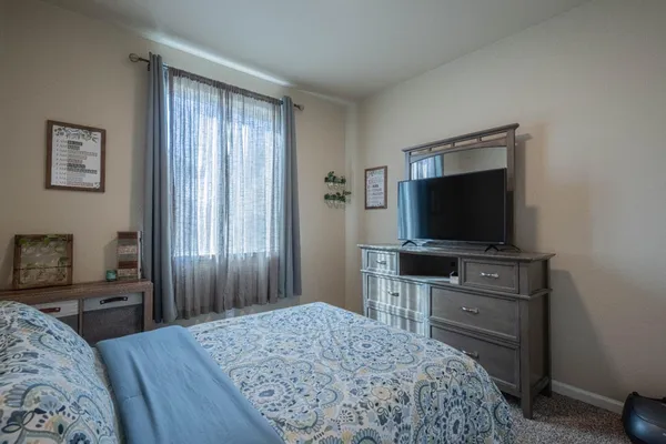 a bedroom with a bed and a television