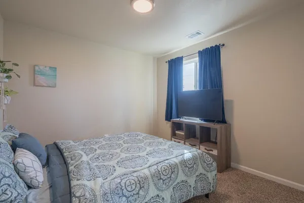 a bedroom with a bed and a window