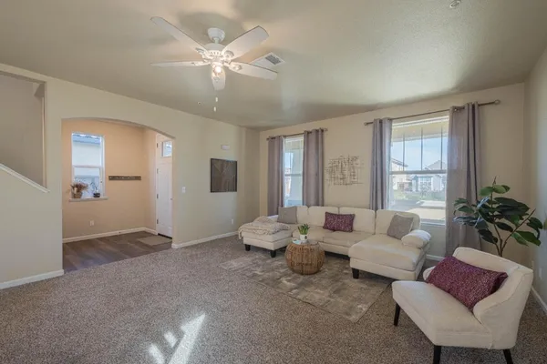 a living room with furniture and large windows