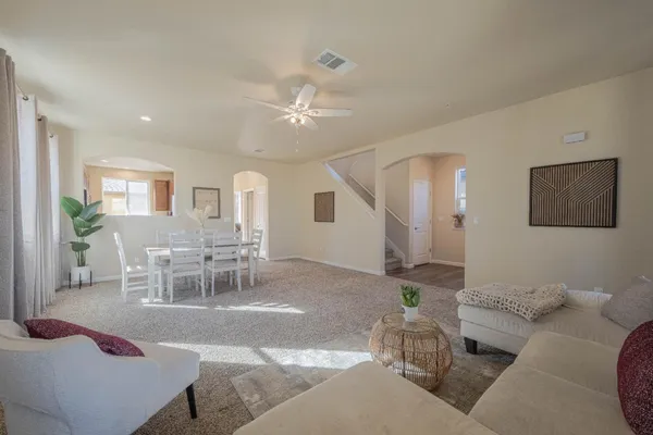 a living room with furniture and wooden floor