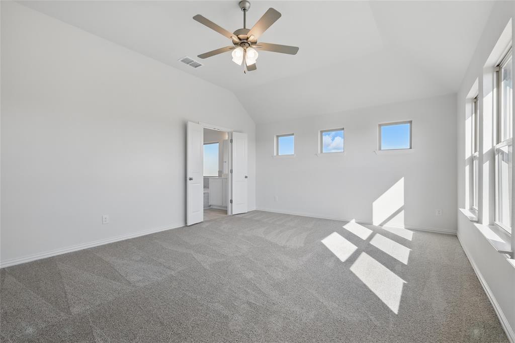 2529 Rivers W Road Anna, TX 75409 - Photo 11 of 22 Unfurnished bedroom featuring light carpet, a ceiling fan, and lofted ceiling