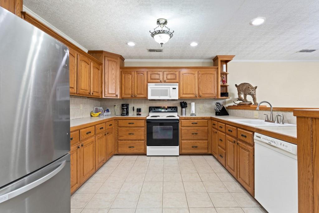 448 North Hill Road Tyler, TX 75706 - Photo 20 of 33 a kitchen with stainless steel appliances granite countertop a stove sink and cabinets